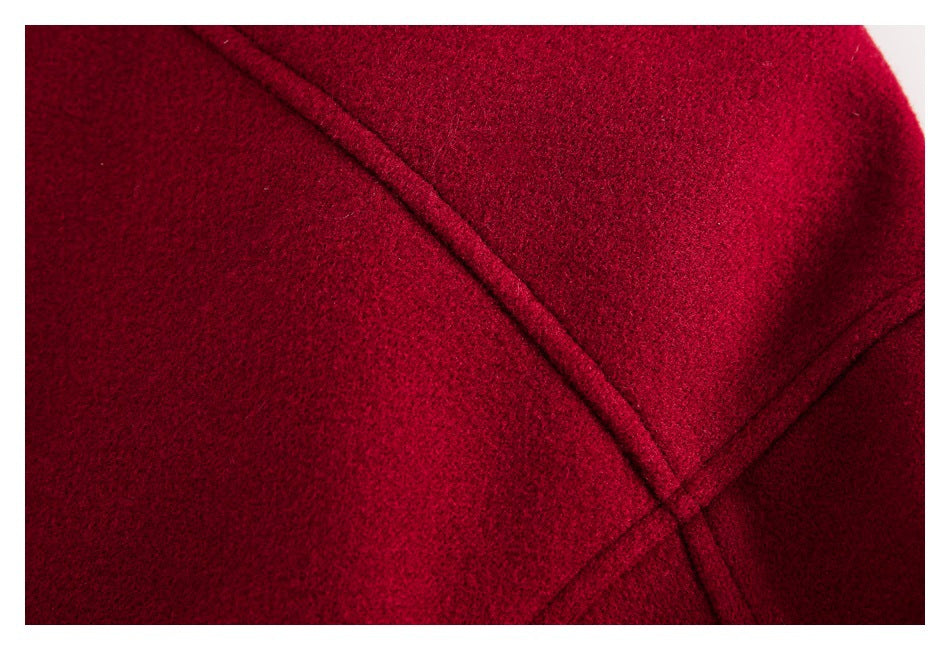 Close-up showing intersecting stitched seams on burgundy fabric.