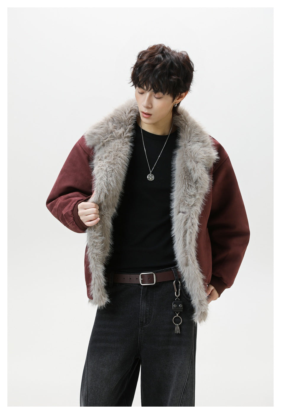 Closer view of a model wearing an open burgundy jacket with plush gray fur trim.