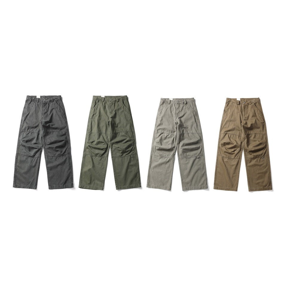 Four pairs of wide-leg utility trousers shown from the front in charcoal, olive, gray, and tan.