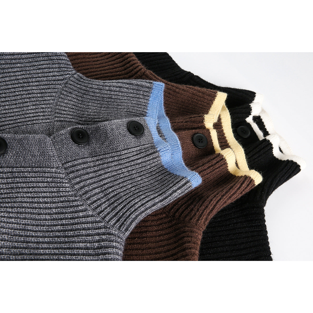 Close-up of gray, brown, and black ribbed button-up sweaters with contrasting trim at the plackets.