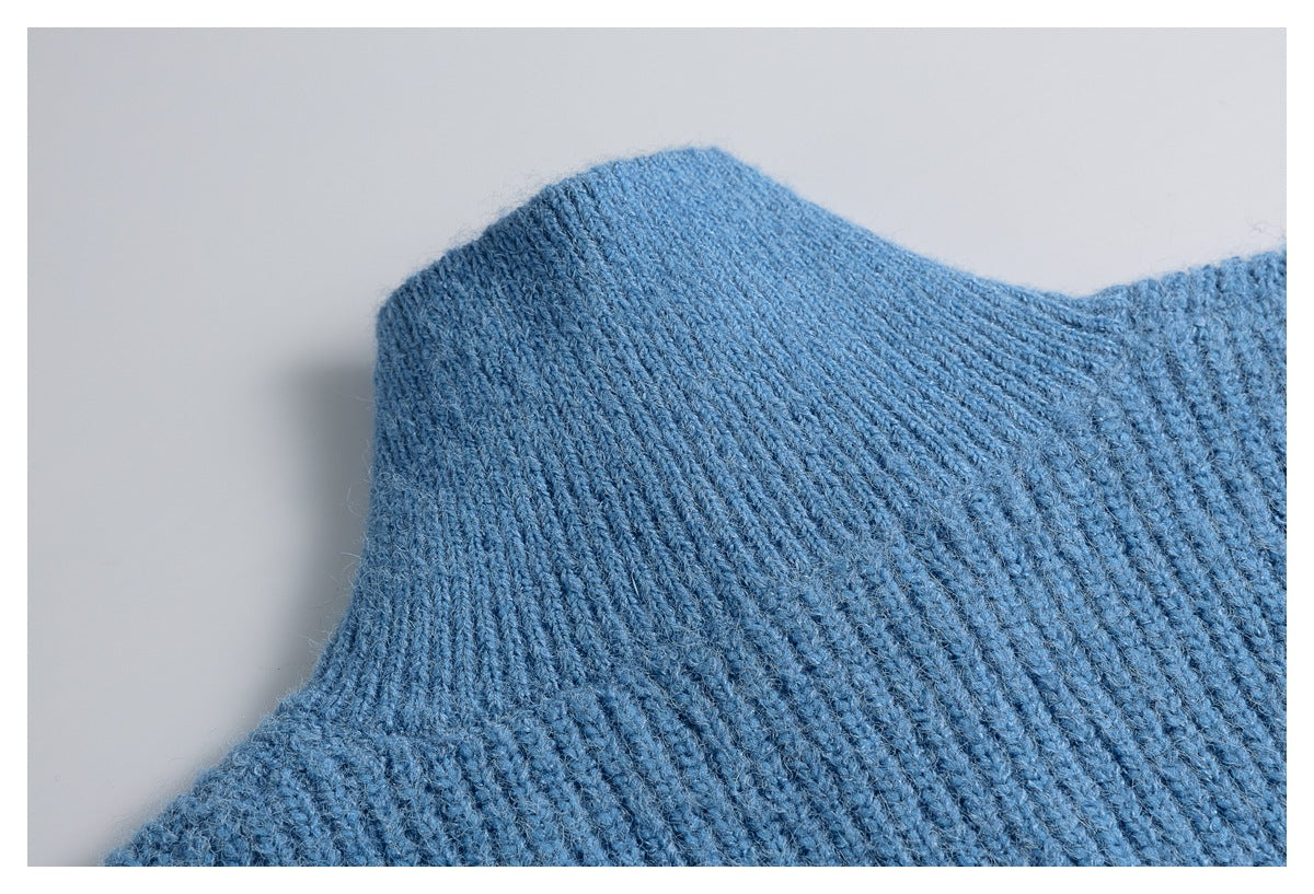 Close-up of the blue sweater’s shoulder and knit stitching.