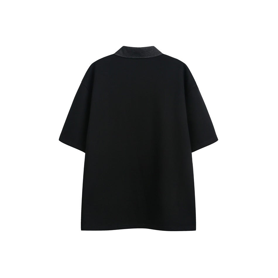 Back view of a plain black short-sleeve polo shirt with a dark collar, shown against a white background.