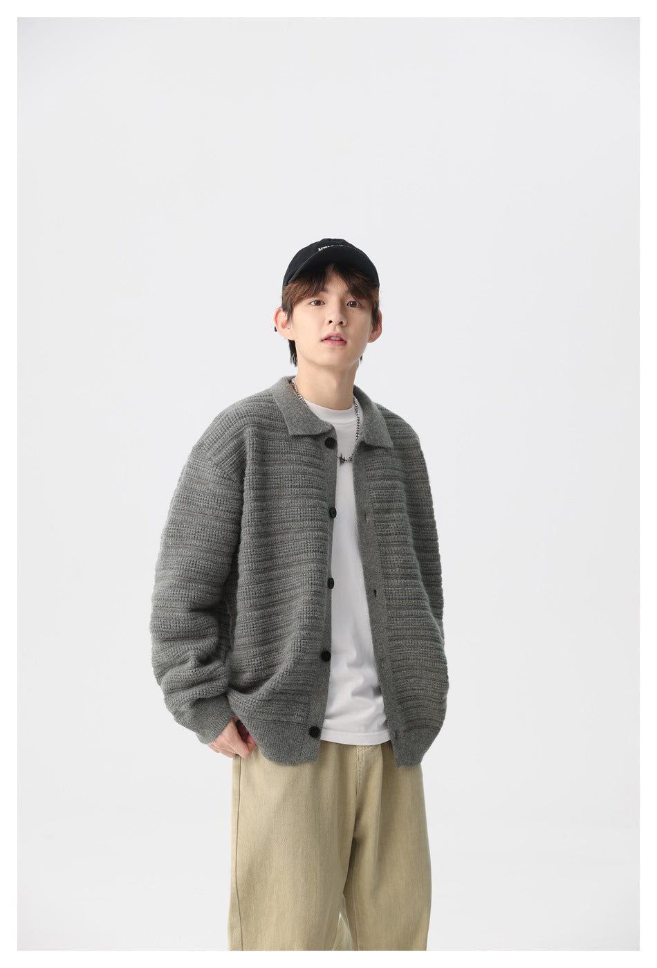 Model wearing a gray horizontally ribbed button-front cardigan with a collar over a white T-shirt.