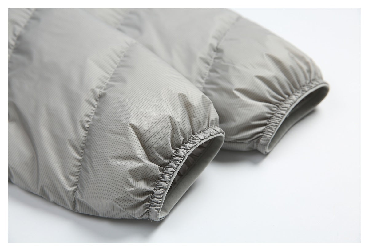 Close-up of two elasticized cuffs on a light gray pinstriped quilted jacket.