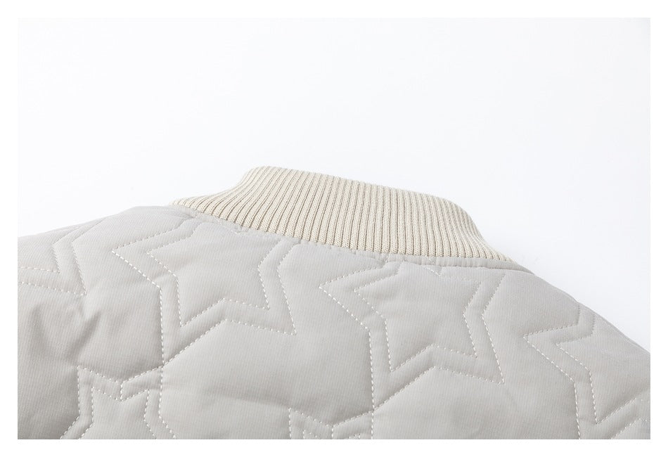 Close-up of the light gray jacket's cream rib-knit collar and star-quilted back.
