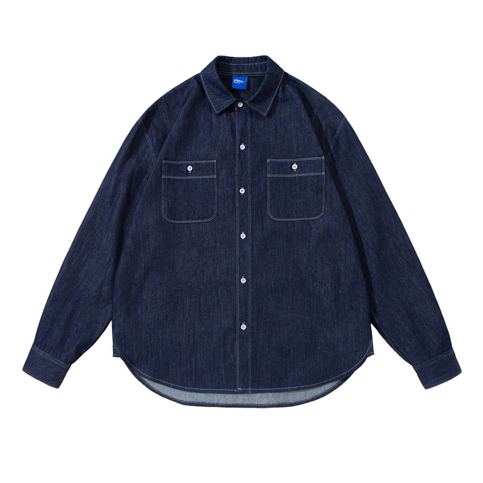 Dark indigo denim button-front shirt, front flat lay with collar, two chest pockets and curved hem