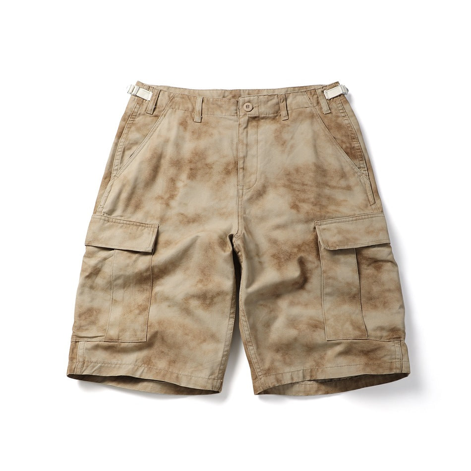 Khaki tie-dye cargo shorts, flat lay front view with flap cargo pockets and cream side buckle tabs