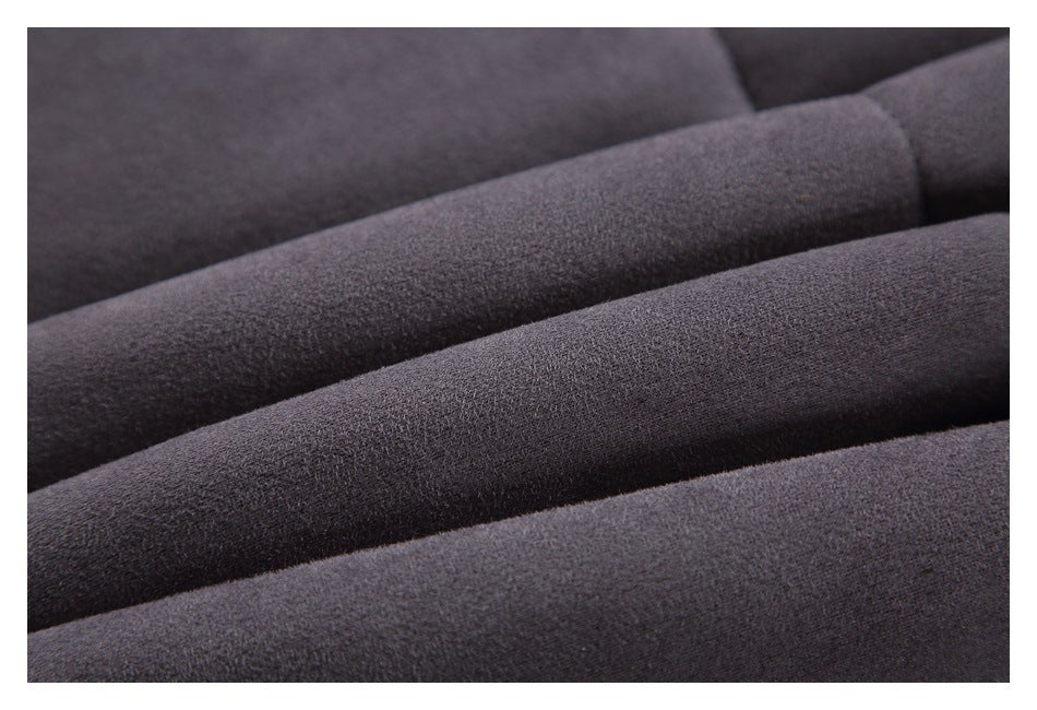 Close-up of dark gray fabric arranged in overlapping folds, showing its surface texture.