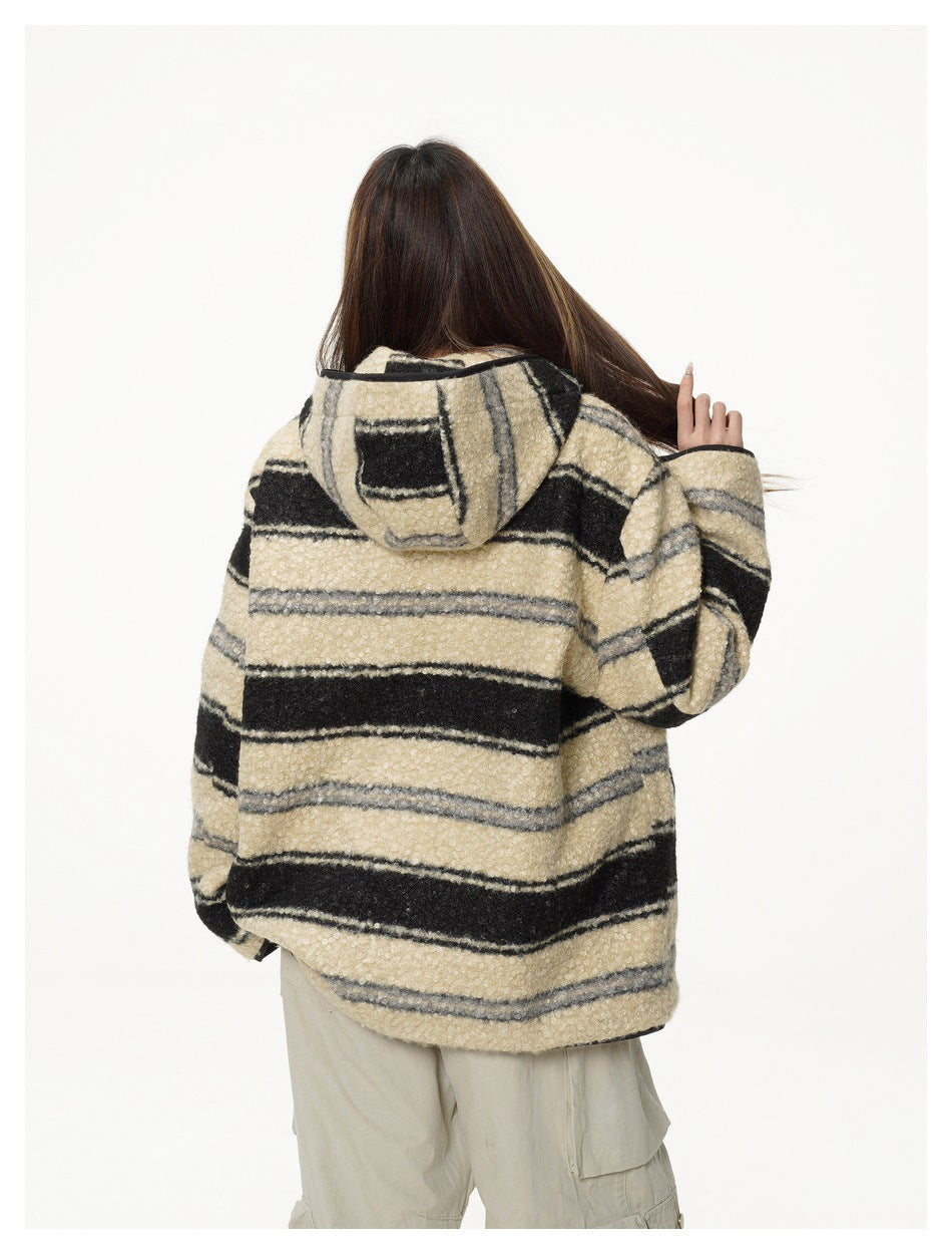 Back view of a model wearing a cream, black, and gray striped hooded jacket and beige cargo pants.