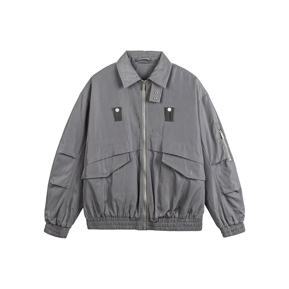 Gray zip-front jacket with spread collar, large flap pockets, sleeve zip pocket and elastic hem on white background