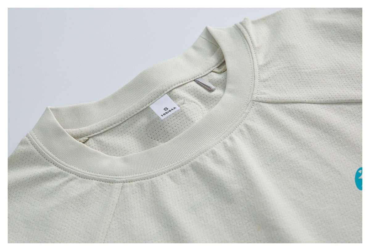 Close-up of the ivory top's ribbed crew neckline, perforated inner fabric, and size label.