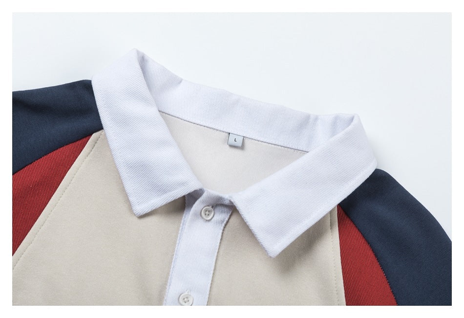 Close-up of the top's white polo collar and buttons, cream front, red shoulder panels, and navy sleeves; size tag reads L.