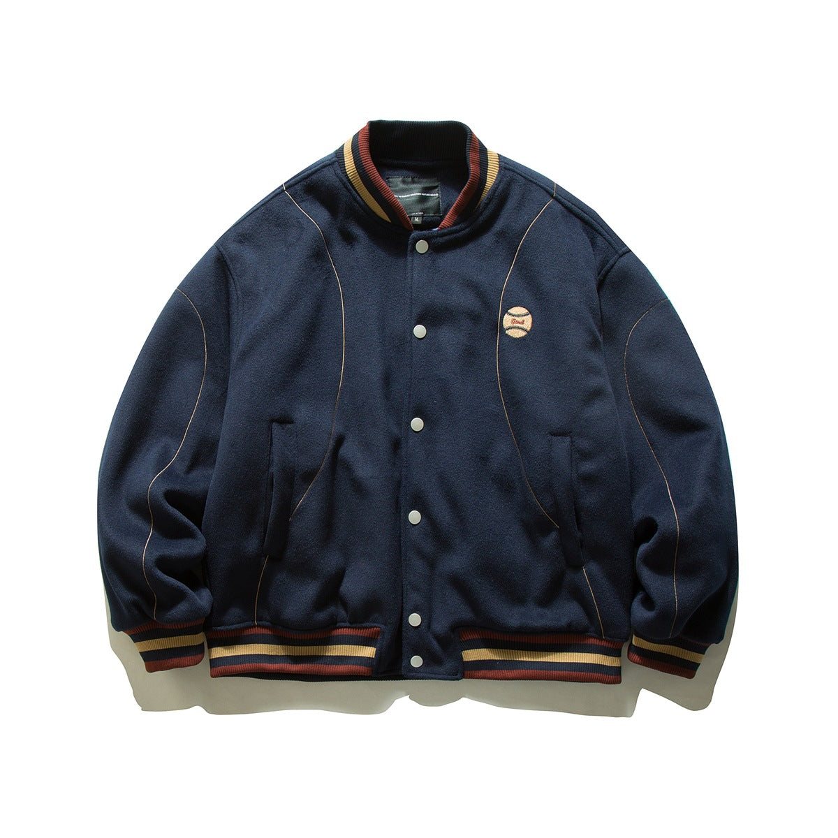 Navy varsity jacket with snap front, striped ribbed collar, cuffs and hem, and an embroidered baseball patch