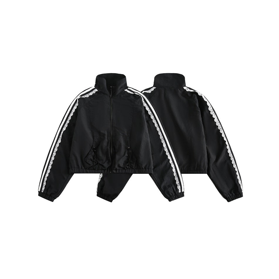 Black cropped zip jacket shown from the front and back, with a high collar, elastic hems and cuffs, and white striped