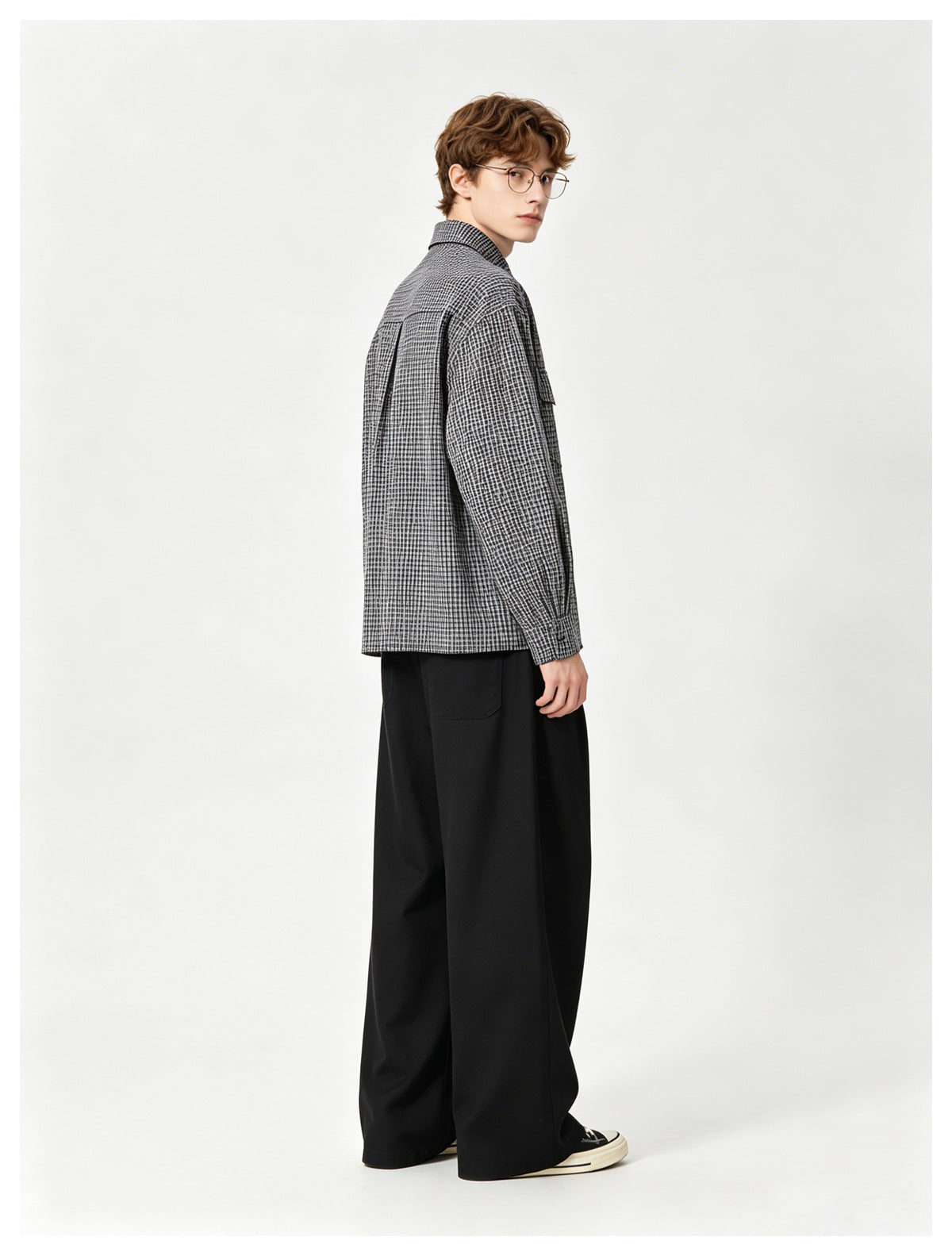 Model wearing a gray-and-black checked long-sleeve shirt, shown from a rear three-quarter angle.