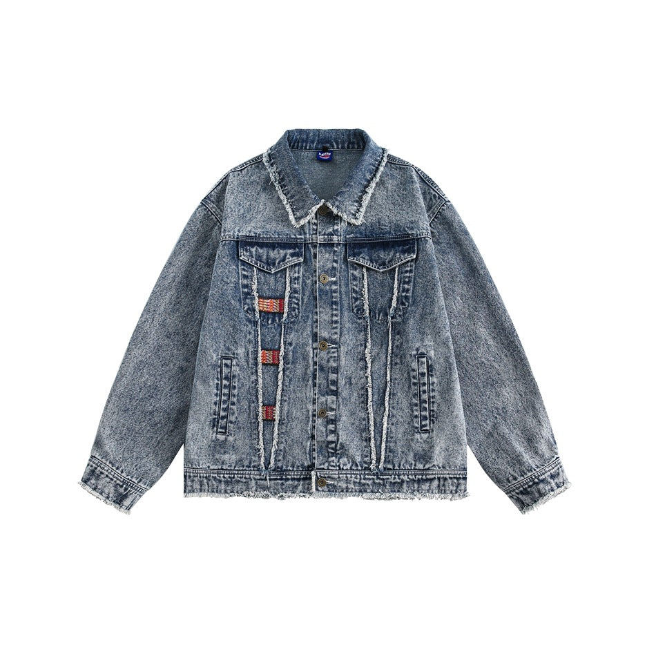 Blue acid-washed denim jacket with frayed collar, hem and cuffs, flap pockets and red woven patches, front flat view