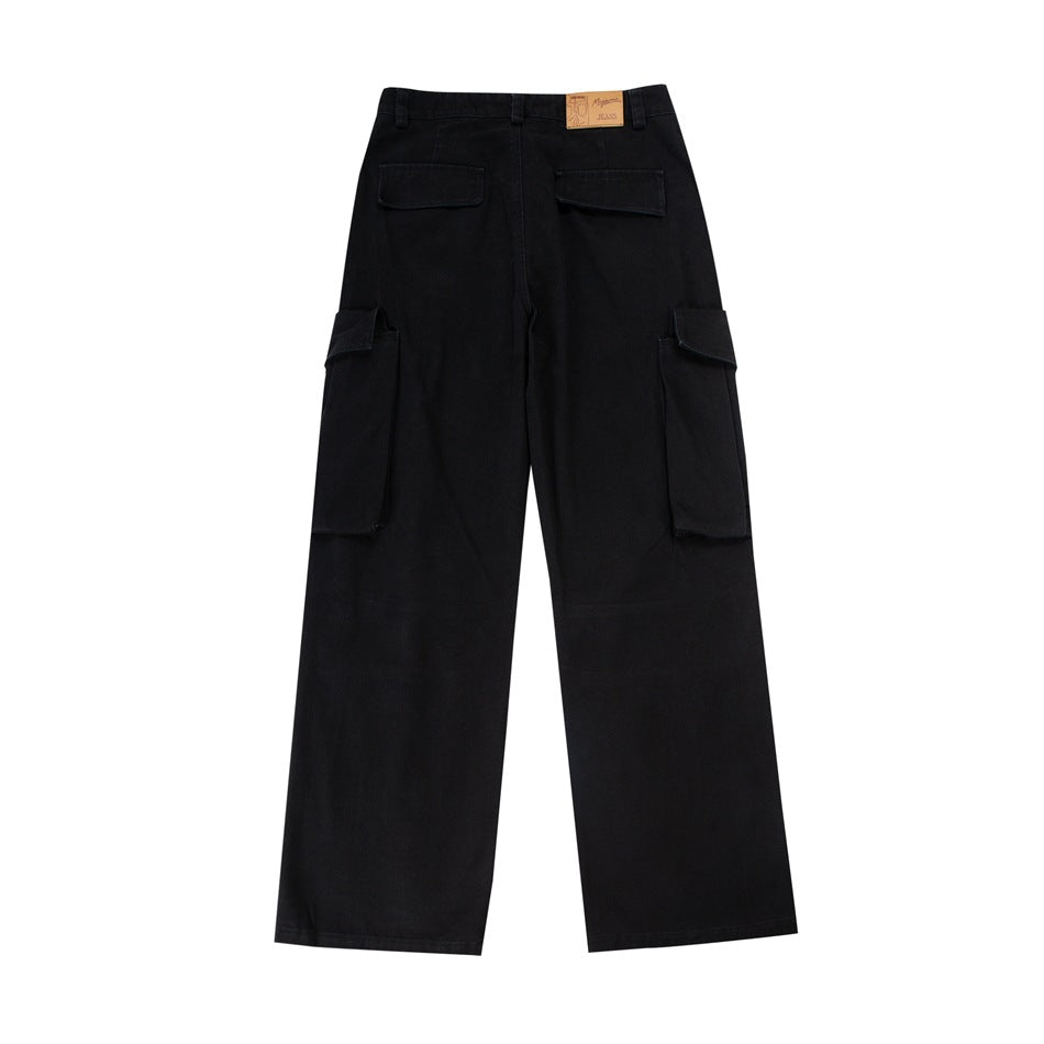 Back view of black wide-leg cargo trousers with two rear flap pockets and large side cargo pockets.