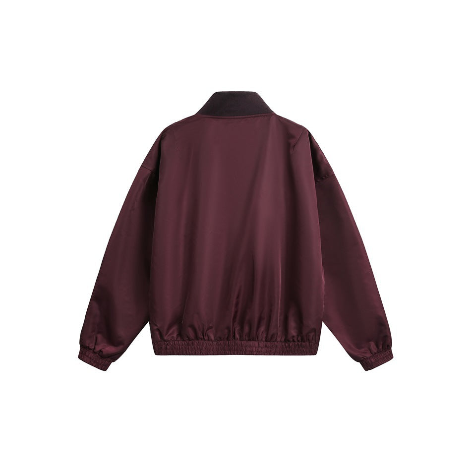 Back view of a burgundy jacket with a black stand collar and elastic cuffs and hem.
