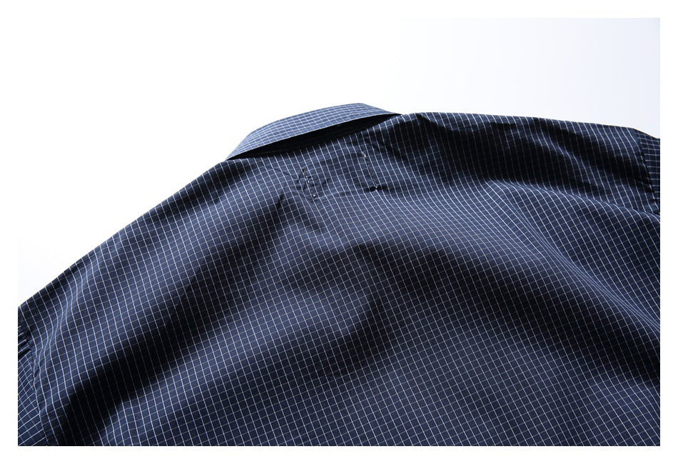 Close-up of the navy check shirt collar and upper back with visible stitching.
