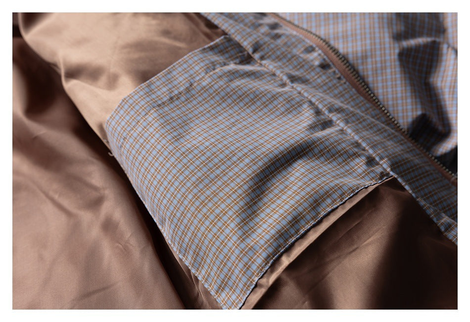 Open blue and tan checked jacket showing its brown lining, zipper, and inner fabric panel.