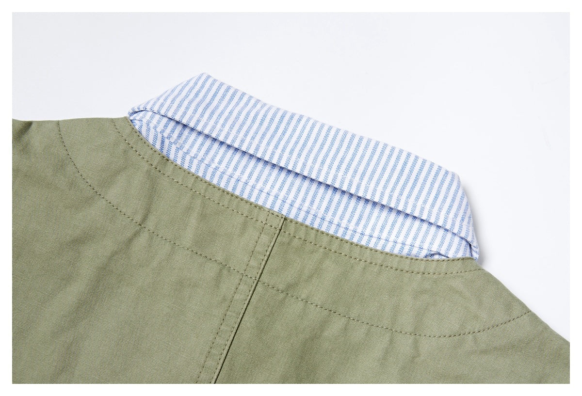 Close-up of an olive garment neckline with a blue-and-white striped contrast collar.