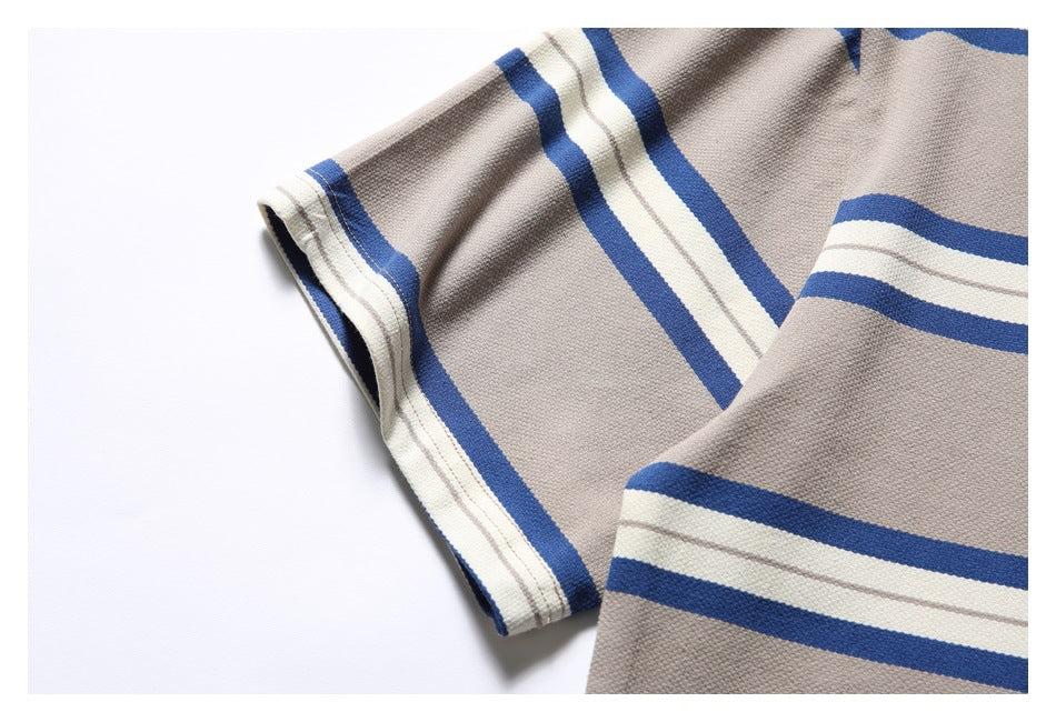 Close-up of the T-shirt’s striped short sleeve and textured taupe fabric.