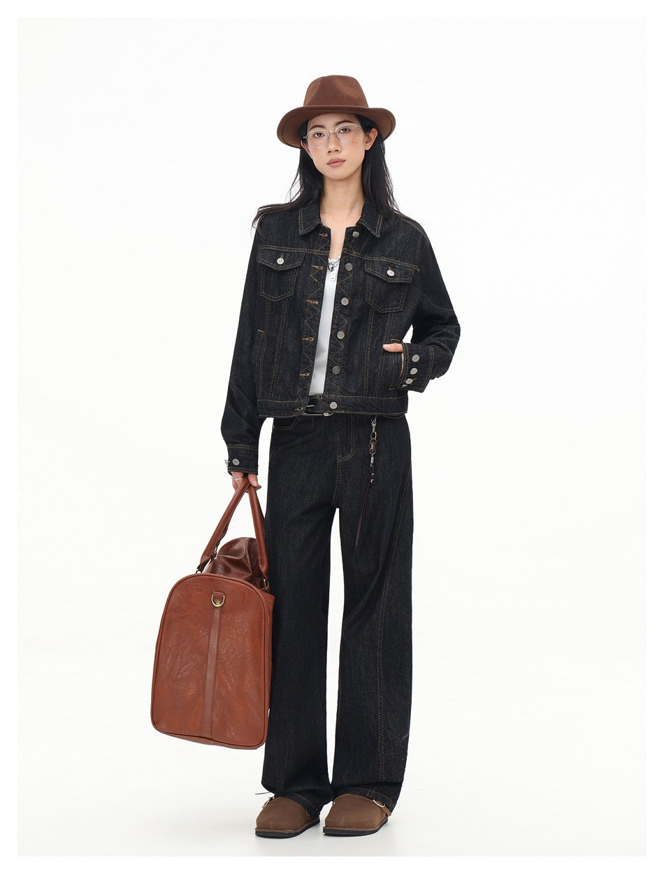 Full-length model wearing a dark indigo denim jacket with button front and flap pockets, paired with matching wide-leg jeans.