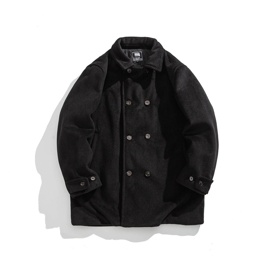 Black double-breasted mid-length coat with turn-down collar and button-tab cuffs, flat lay front view