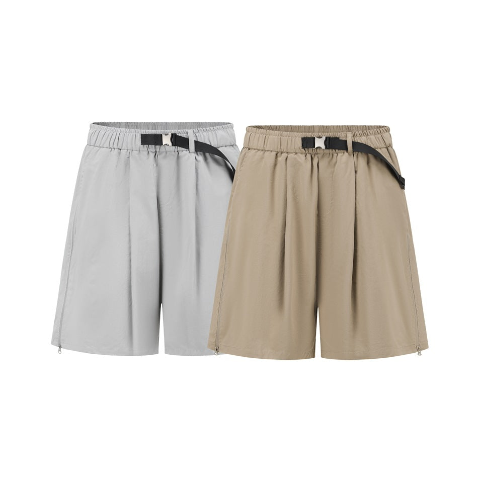 Front view of two pairs of loose shorts, one light gray and one tan, each with an elastic waist and black belt.