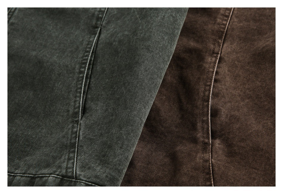 Close-up of charcoal and brown washed jacket fabric and seam details.