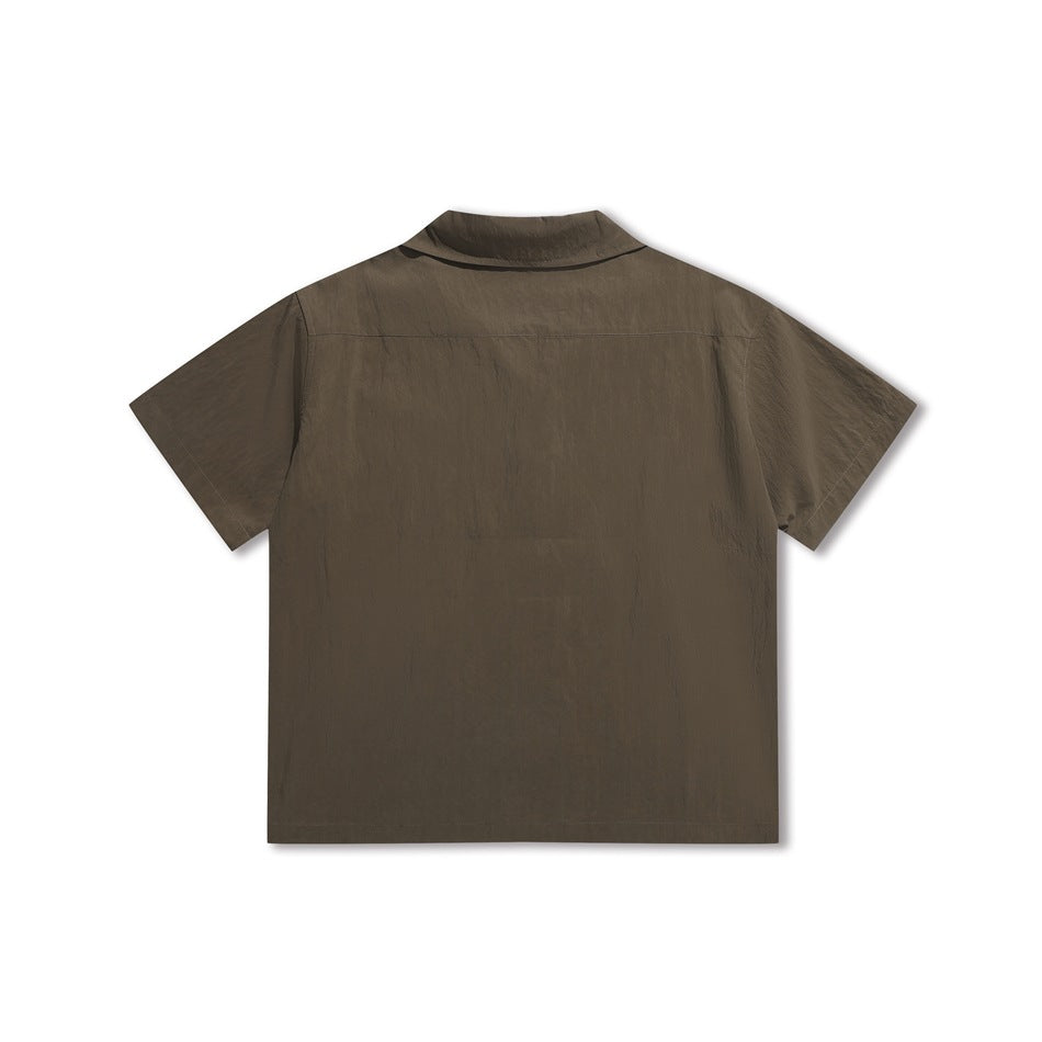 Back view of a brown short-sleeve button-up shirt with a yoke seam and pointed collar.