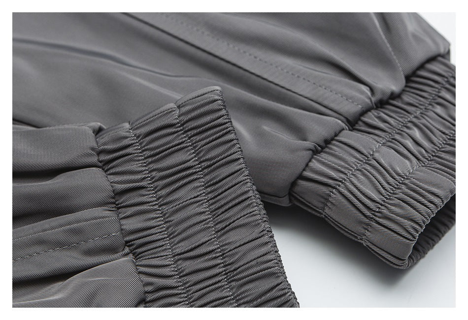 Close-up of gray garment elastic cuffs with gathered stitching and seam details.