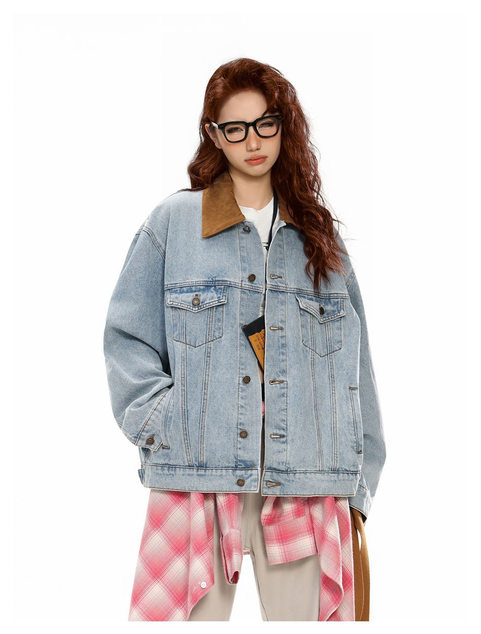 Model wearing an oversized light-wash denim jacket with a brown collar and flap chest pockets, layered over a pink plaid