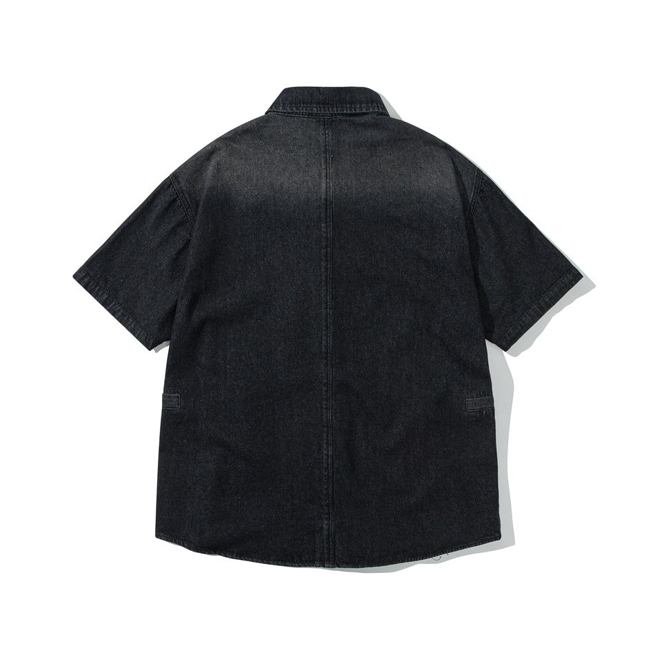 Back view of a black short-sleeve denim shirt with a pointed collar and a center back seam.