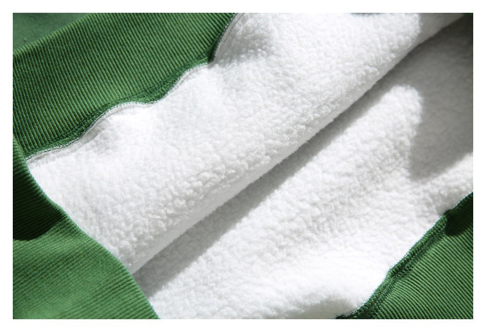 Close-up of the thick white textured lining framed by green sweatshirt fabric.