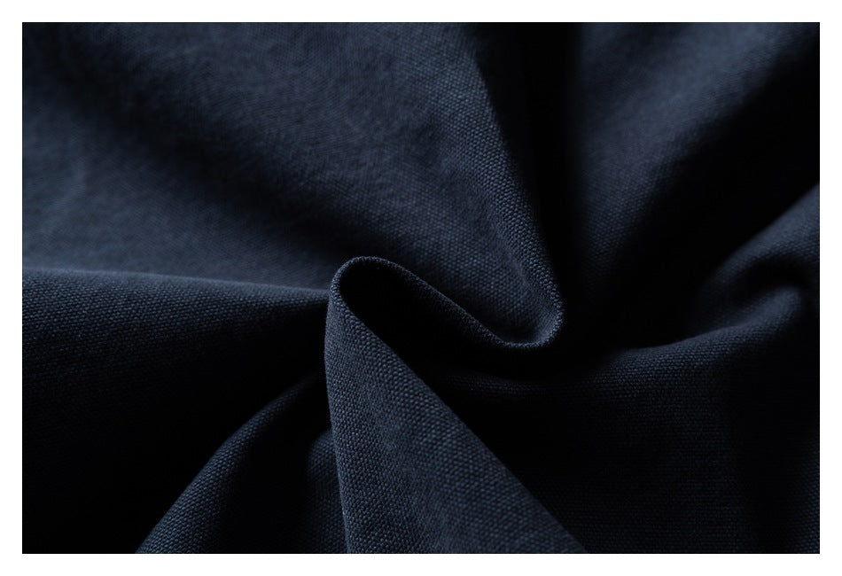 Close-up of dark navy woven fabric gathered into soft folds.