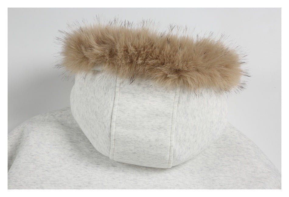Rear view of a light gray marled hood topped with thick tan fur trim.