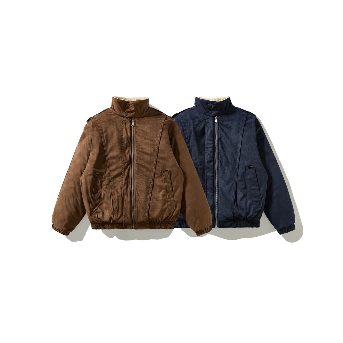 Front views of two zip-front jackets, one brown and one navy, with stand collars and ribbed cuffs and hems.