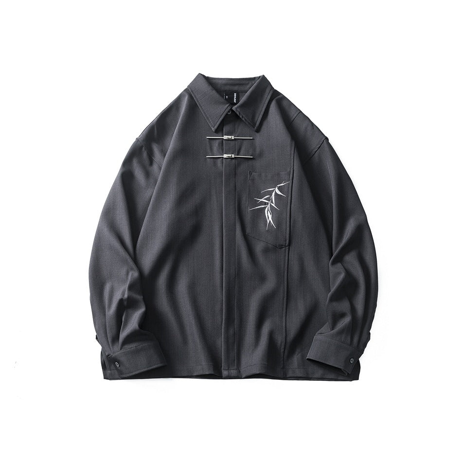 Dark gray long-sleeve shirt flat front view with two metal bar closures and bamboo embroidery on the chest pocket