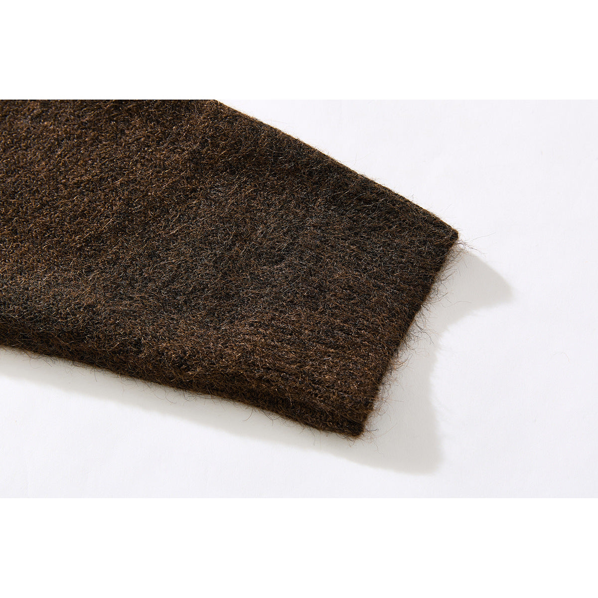 Close-up of the brown knit sweater's sleeve end and fuzzy surface texture.