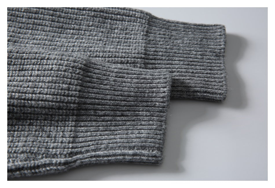 Close-up of a gray rib-knit sweater sleeve and cuff.