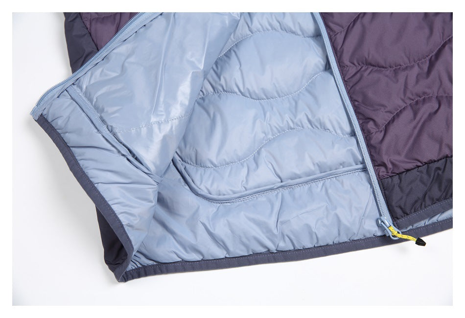 Close-up of an open quilted jacket with pale blue lining and pocket, bordered by plum and charcoal panels.