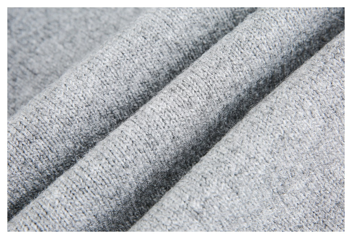 Macro view of the textured knit stitches in light gray fabric.