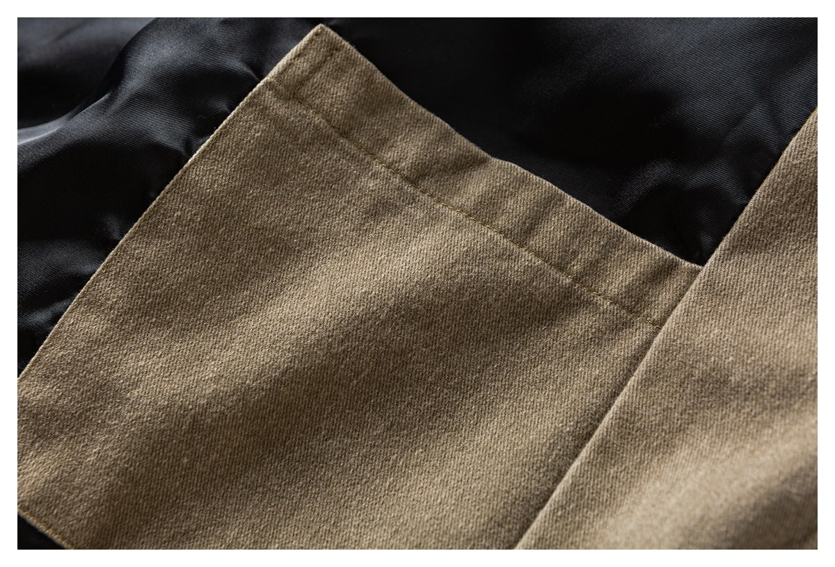 Close-up of a tan garment panel with black lining visible around its edge.