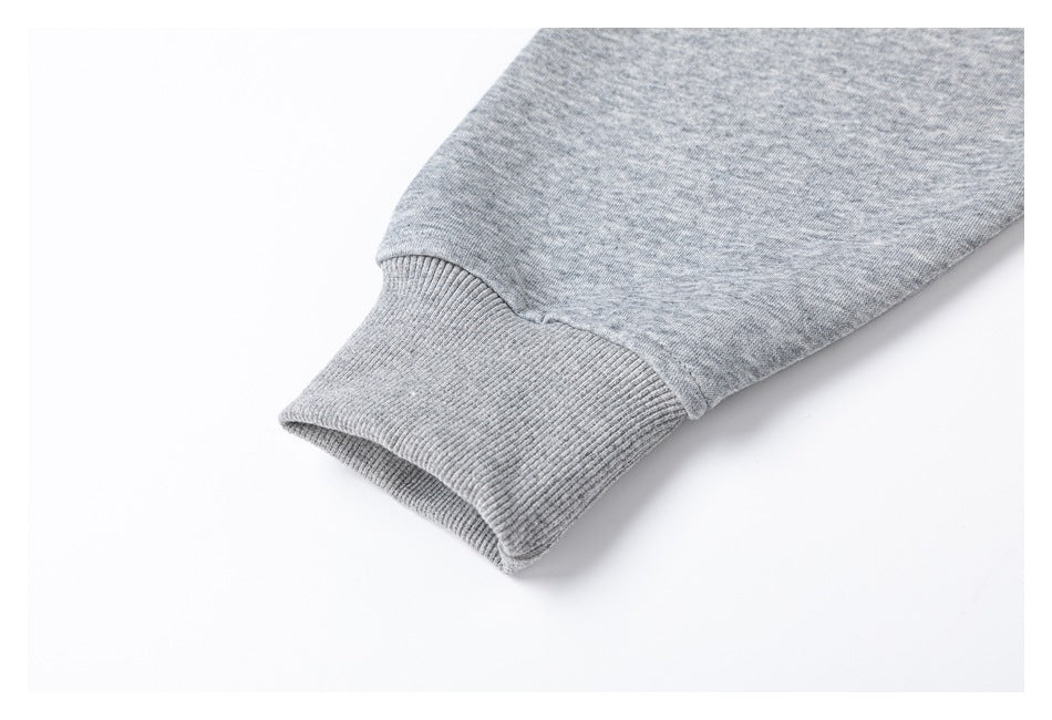 Close-up of a ribbed cuff on the gray top's sleeve.