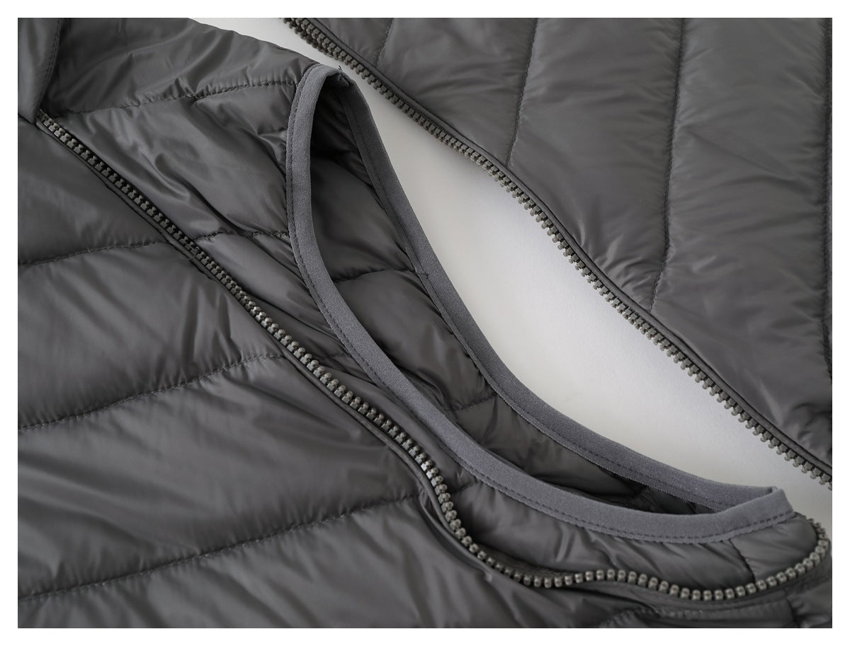 Close-up of the dark gray quilted jacket's neckline, inner trim, and front zipper.