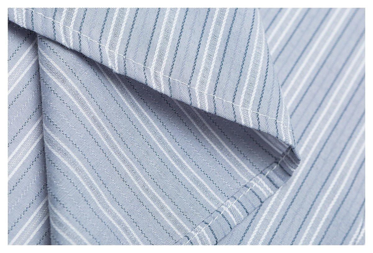 Close-up of light blue fabric with narrow white and dark blue stripes and stitched folded edges.