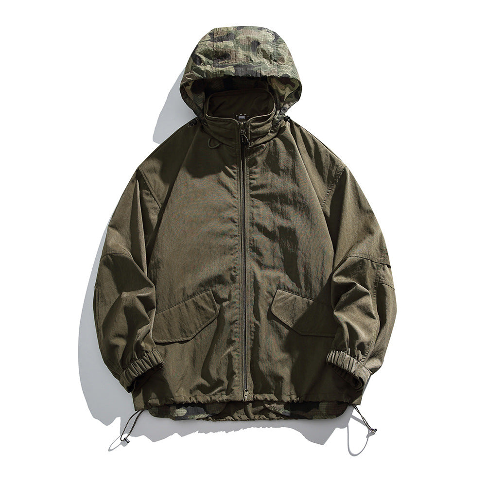 Army green hooded zip jacket with green camouflage hood lining, flap pockets and drawcord hem, flat lay