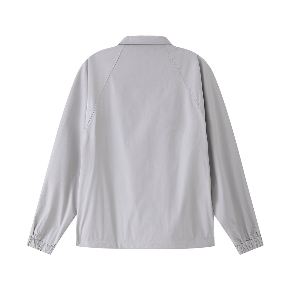 Back view of a light gray jacket with a pointed collar, raglan sleeves and gathered cuffs.