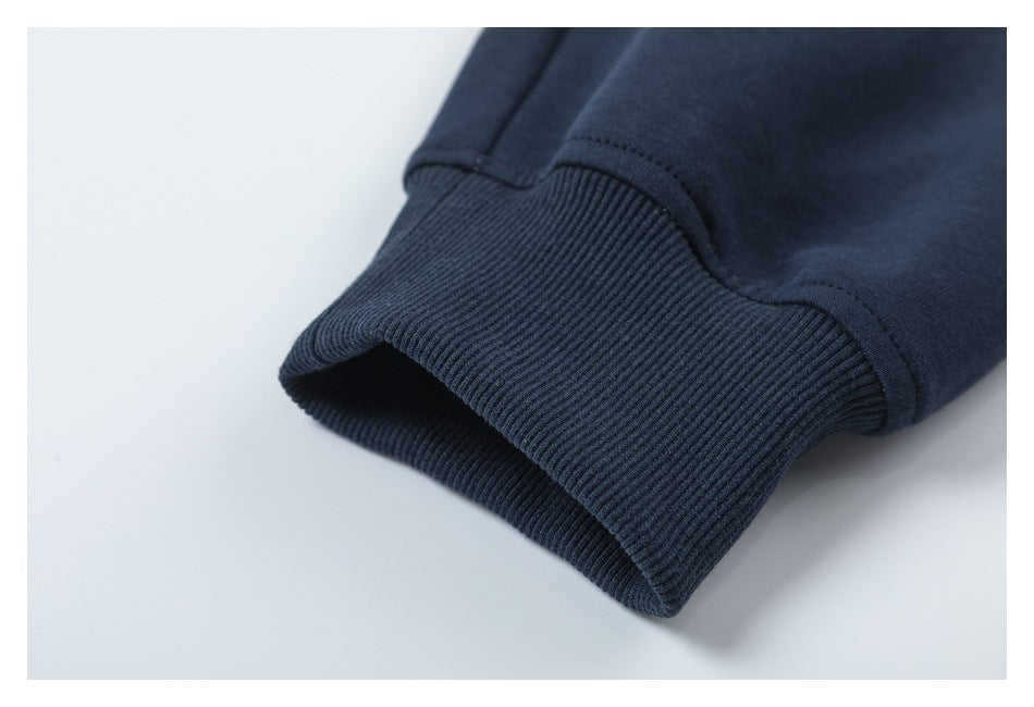 Close-up of a dark navy sleeve ending in a wide ribbed cuff.